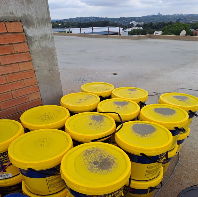 Fiber reinforced liquid rubber for concrete roof slabs and to fill cracks in concrete slab